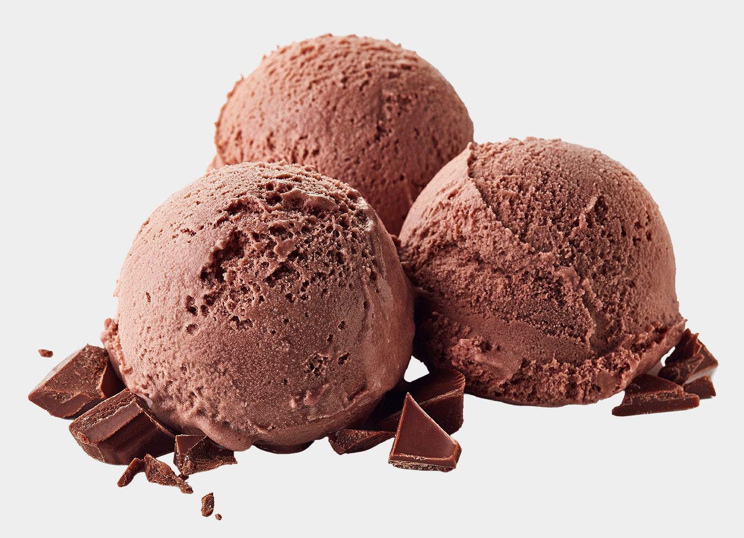Three scoops of rich chocolate ice cream surrounded by chocolate chunks.